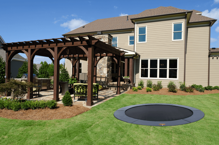 Inground trampoline installation and custom backyard pergola in Dallas by Medina Landscape Services